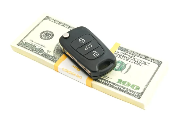 Сто долларов банкноты и ключи от машины на белом Стоковое Фото
