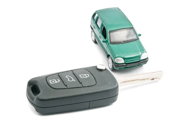 Black car keys and green car — Stock Photo, Image