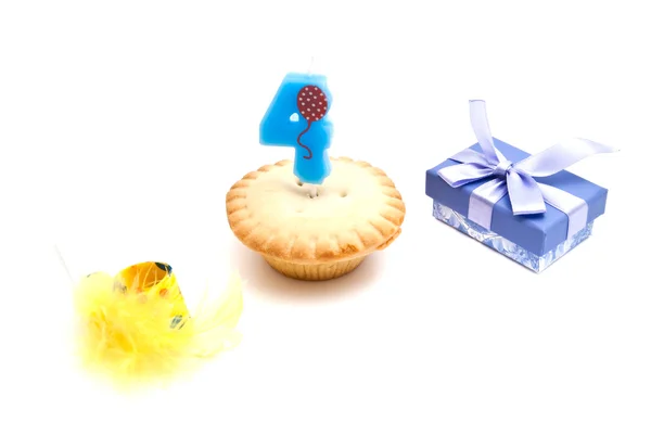 Cupcake with four years birthday candle, gift and whistle — Stock Photo, Image