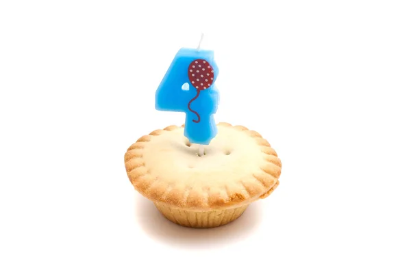 Cupcake with four years birthday candle on white — Stock Photo, Image