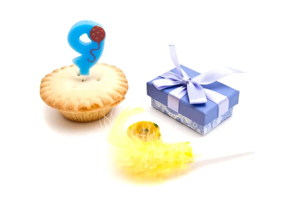 Cupcake with nine years birthday candle, gift and whistle — Stock Photo, Image