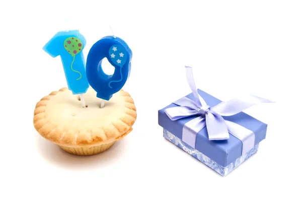 Cupcake with ten years birthday candle and gift — Stock Photo, Image