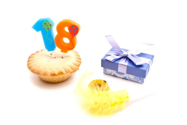 Cupcake with eighteen years birthday candle, gift and whistle on — Stock Photo, Image