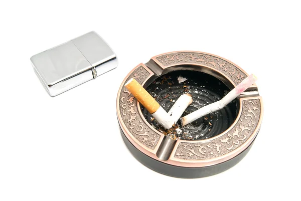 Cigarette butts in ashtray and metal lighter — Stock Photo, Image