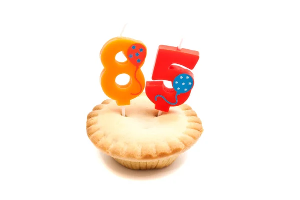 Cupcake with eighty five years birthday candle on white — Stock Photo, Image