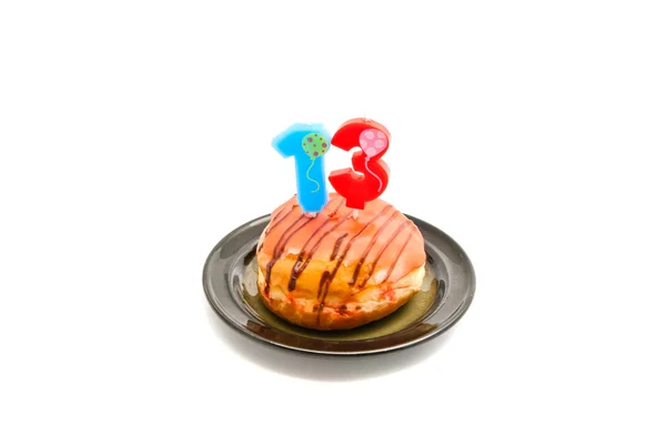 Donut with thirteen years birthday candle — Stock Photo, Image