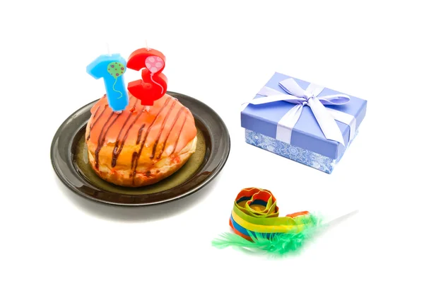 Donut with thirteen years birthday candle, whistle and gift on w — Stock Photo, Image