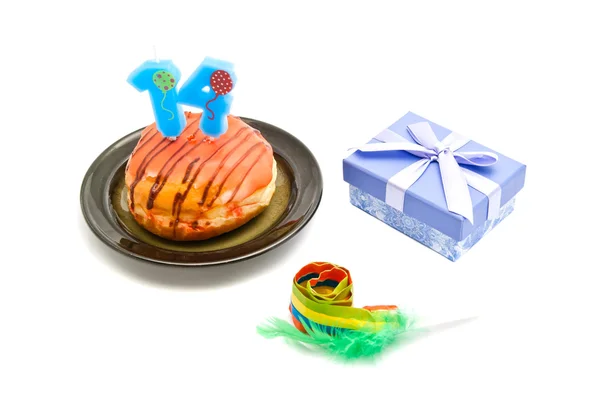 Donut with fourteen years birthday candle, whistle and gift on w — Stock Photo, Image