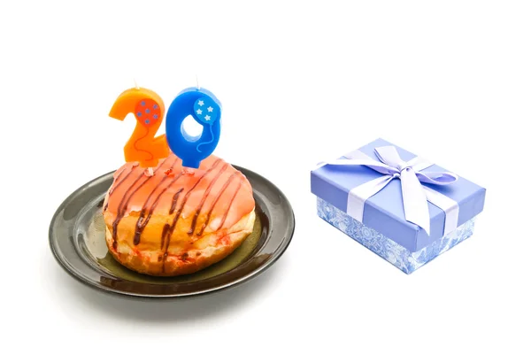 Donut with twenty years birthday candle and gift on white — Stock Photo, Image