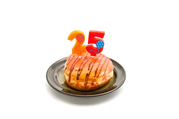 Donut with twenty five years birthday candle on white — Stock Photo, Image