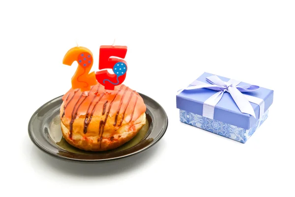 Donut with twenty five years birthday candle and gift on white — Stock Photo, Image