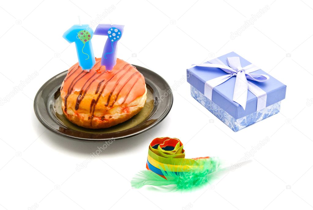 donut with seventeen years birthday candle, whistle and gift on 