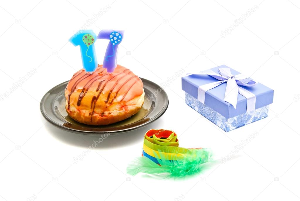donut with seventeen years birthday candle, whistle and gift 