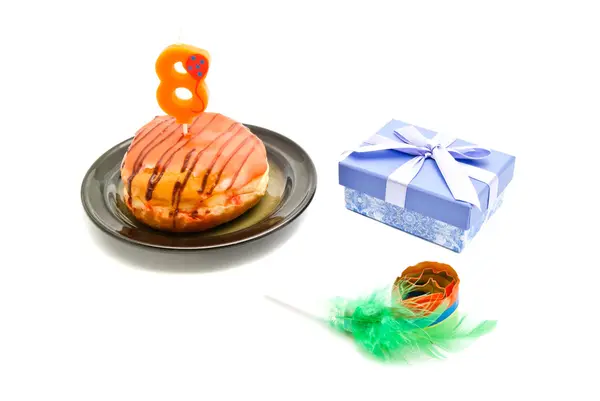 Donut with eight years birthday candle, whistle and gift — Stock Photo, Image