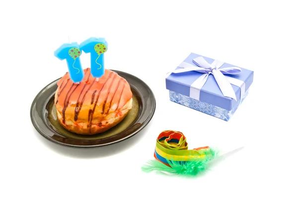 Donut with eleven years birthday candle, whistle and gift — Stock Photo, Image
