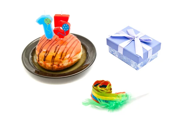 Donut with fifteen years birthday candle, whistle and gift — Stock Photo, Image