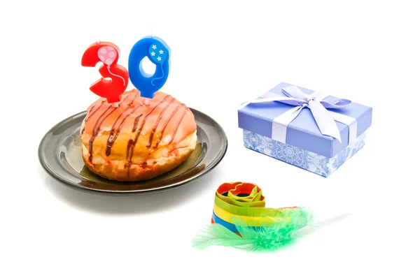 Donut with thirty years birthday candle, whistle and gift — Stock Photo, Image