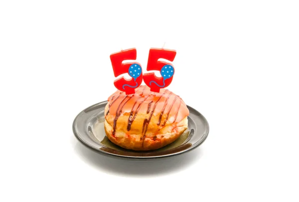 Donut with fifty five years birthday candle on white — Stock Photo, Image