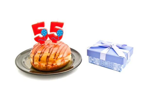 Donut with fifty five years birthday candle and gift — Stock Photo, Image