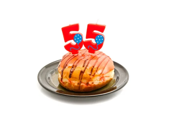 Donut with fifty five years birthday candle — Stock Photo, Image