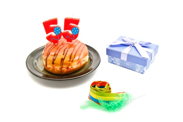 Donut with fifty five years birthday candle, whistle and gift on — Stock Photo, Image