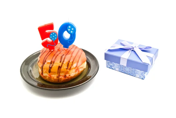 Donut with fifty years birthday candle and gift — Stock Photo, Image