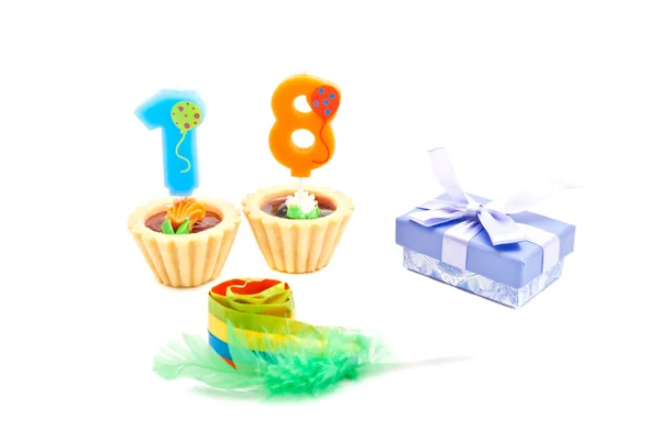 Tårta med arton års födelsedag ljus, visselpipa och gåva — Stockfoto