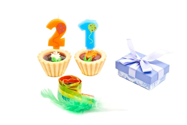 Cakes with twenty one years birthday candles, whistle and gift o — Stock Photo, Image