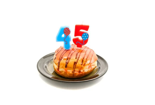 Donut com quarenta e cinco anos vela de aniversário — Fotografia de Stock