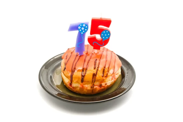 Donut com setenta e cinco anos vela de aniversário — Fotografia de Stock