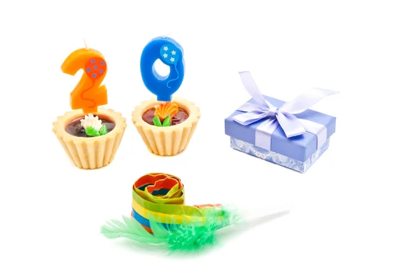 Cakes with twenty years birthday candles, whistle and gift on wh — Stock Photo, Image