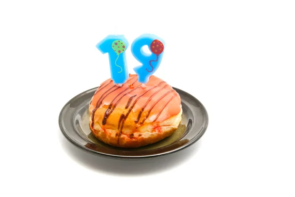 Donut with nineteen years birthday candle — Stock Photo, Image