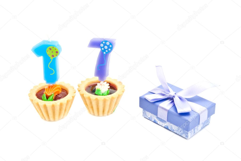 cakes with seventeen years birthday candles and gift on white 