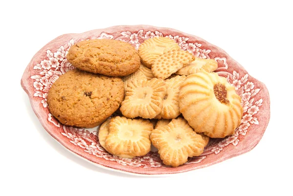 Vário de biscoitos em uma chapa no branco — Fotografia de Stock