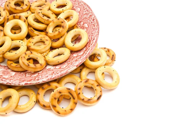 Bagels em uma chapa rosa no branco — Fotografia de Stock