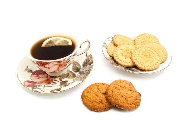 Mug of tea with lemon and cookies — Stock Photo, Image