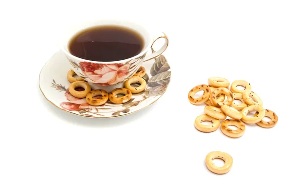 Many bagels and cup of tea on white — Stock Photo, Image