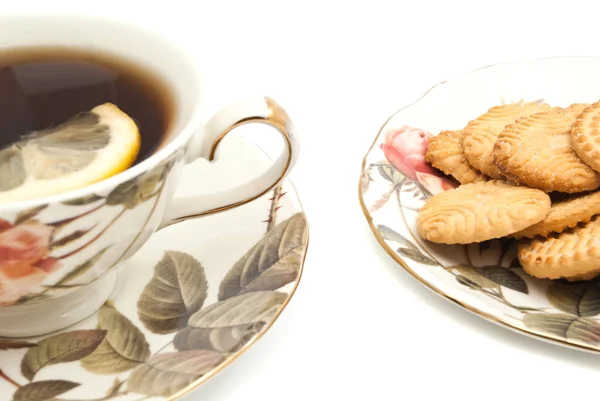 Mug of tea with lemon and delicious cookies — Stock Photo, Image