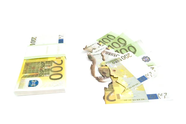 Сожженные счета и пачка евро — стоковое фото