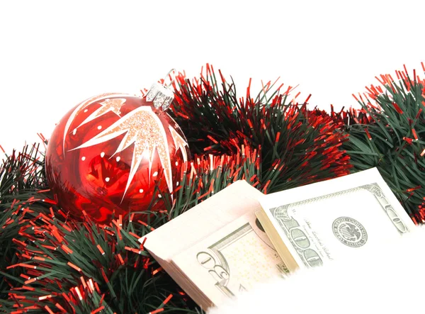 Christmas tree toy, tinsel and banknotes — Stock Photo, Image