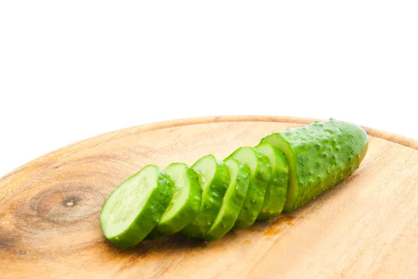 Cucumber with slices on cutting board — Stock Photo, Image