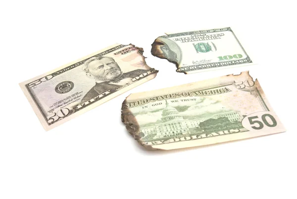 Burnt bills of dollars on white — Stock Photo, Image