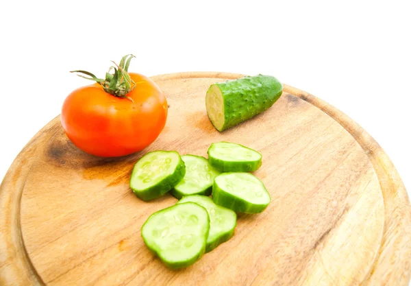 Concombre frais et tomate sur planche à découper — Photo