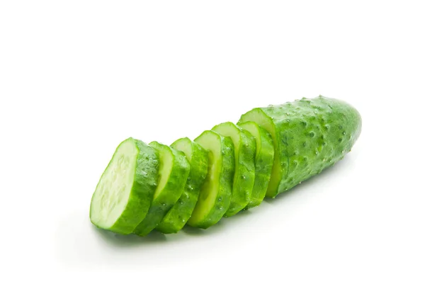 Half a fresh cucumber with slices — Stock Photo, Image