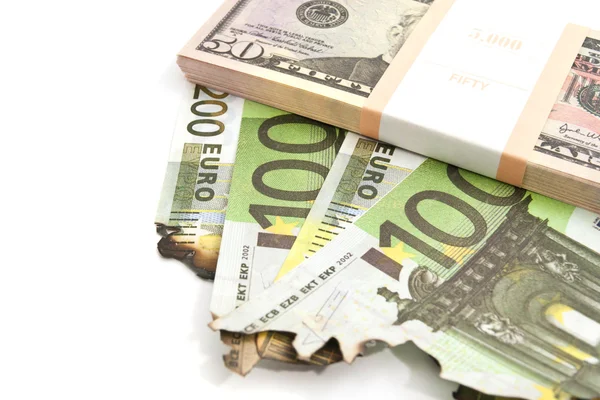 Pack of dollars and burned euros — Stock Photo, Image