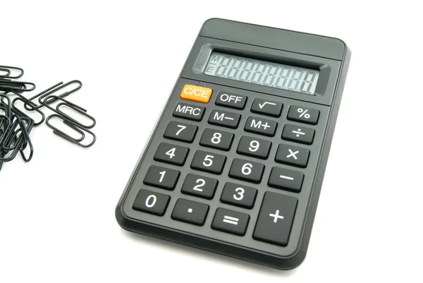 Черный офисный калькулятор и зажимы — стоковое фото