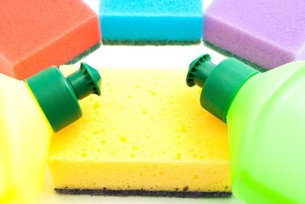 different sponges and two bottles of detergent