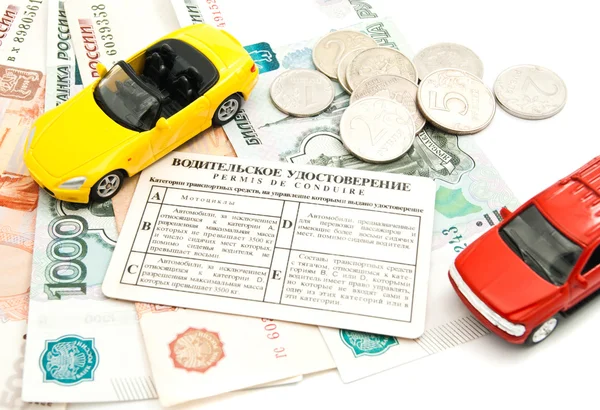 Two cars, driving license and banknotes — Stock Image Two cars, driving license and banknotes Royalty Free Stock Photos