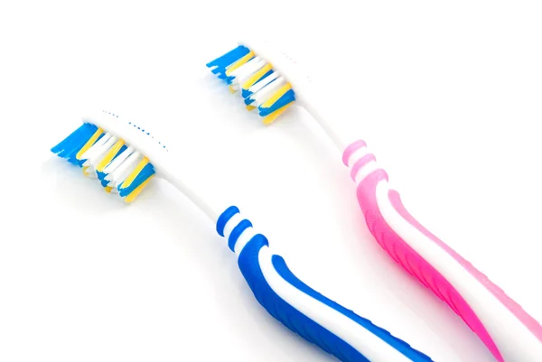 Cepillos de dientes rosa y azul — Foto de Stock