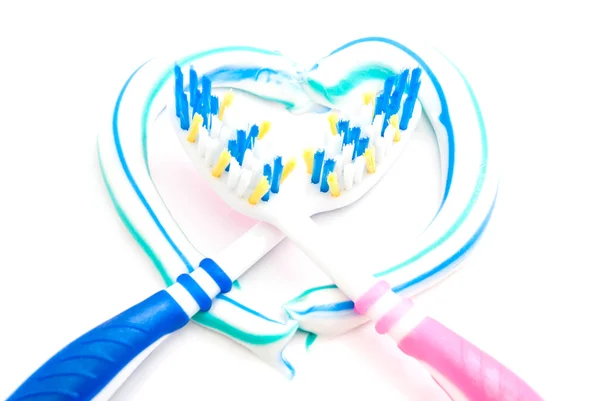 Two toothbrushes in the heart — Stock Photo, Image